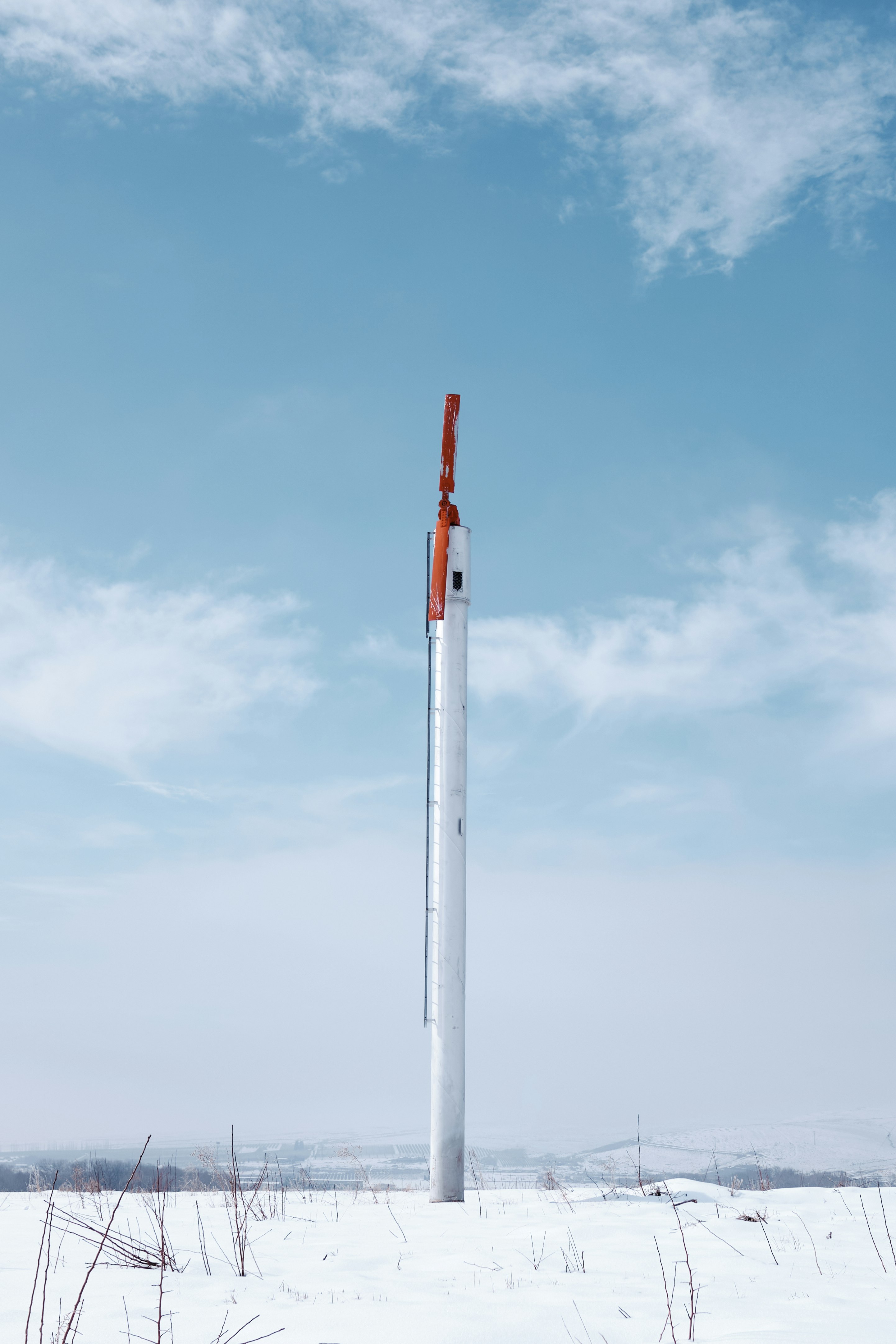 white and red metal pole under blue sky during daytime